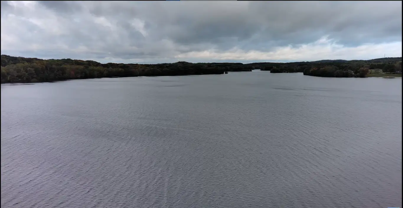 Calm river under cloudy sky